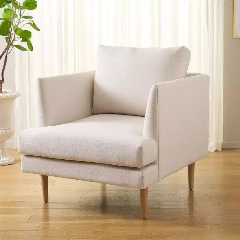 Poltrona imbottita in lino con gambe in legno