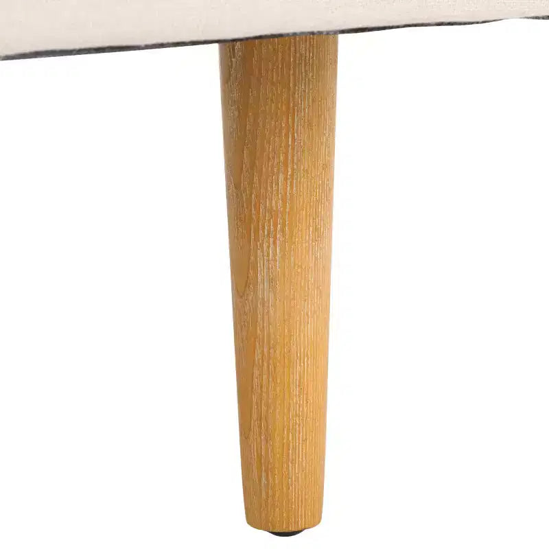 Poltrona imbottita in lino con gambe in legno